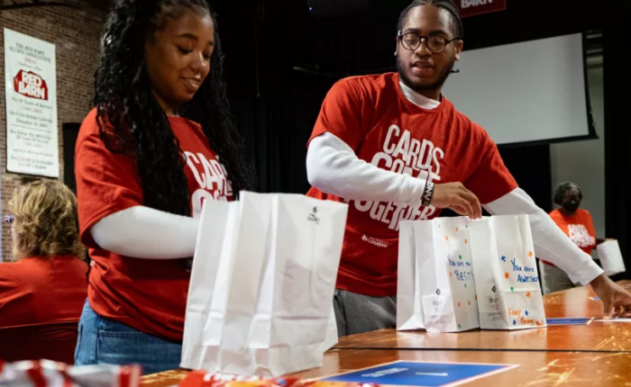Volunteers assemble and decorate snack kits at the Red Barn for Metro United Way’s nonprofit partners during Cards Come Together.
