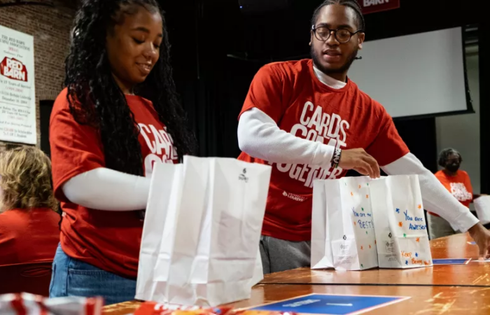 Volunteers assemble and decorate snack kits at the Red Barn for Metro United Way’s nonprofit partners during Cards Come Together.