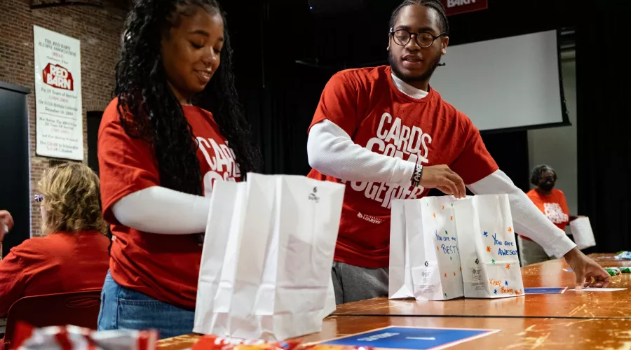 Volunteers assemble and decorate snack kits at the Red Barn for Metro United Way’s nonprofit partners during Cards Come Together.